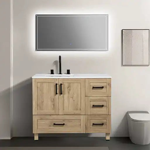 A light wood bathroom vanity with a white countertop, black fixtures, and multiple drawers and cabinets.