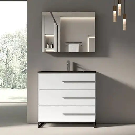 Modern white bathroom vanity with black handles and a dark countertop.