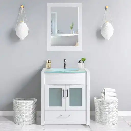 White bathroom vanity with a glass basin, mirror, and two wicker baskets.