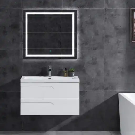 White floating bathroom vanity with a lighted mirror.