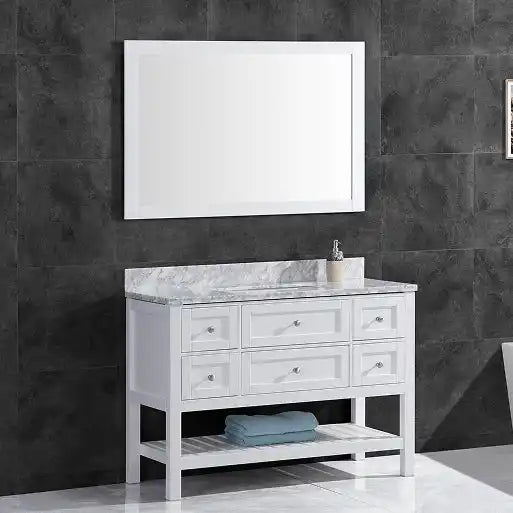 A white bathroom vanity with a marble countertop, silver hardware, and an open slatted shelf.