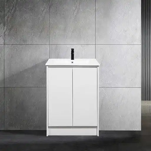 White bathroom vanity with two cabinet doors and a black faucet.